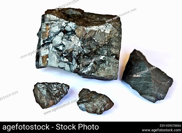 Close up of a selection of small Manganese Ore rocks on a white background