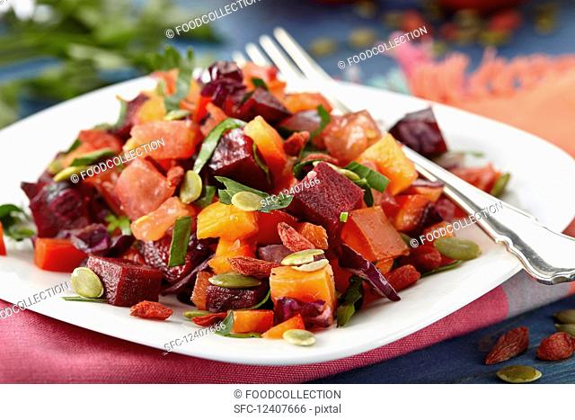Vegan beetroot salad with carrots and pumpkin seeds