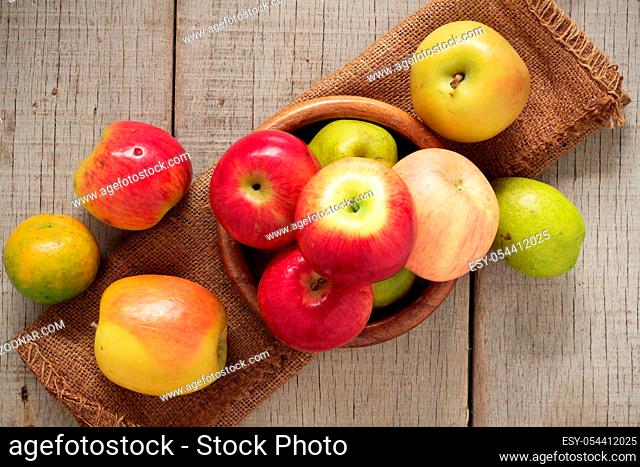 Apples in a bowl on the old wooden floor