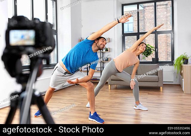 couple recording home yoga class video