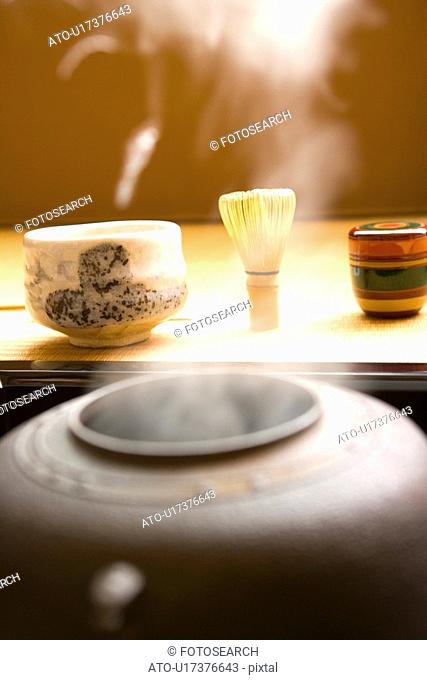 Steam coming out of a tea kettle, Japanese tea set on Tatami mats, close up, Japan