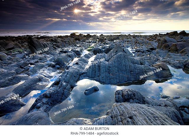 Rock pools and eroded rocks ledges at Sandymouth Bay in North Cornwall, England, United Kingdom, Europe