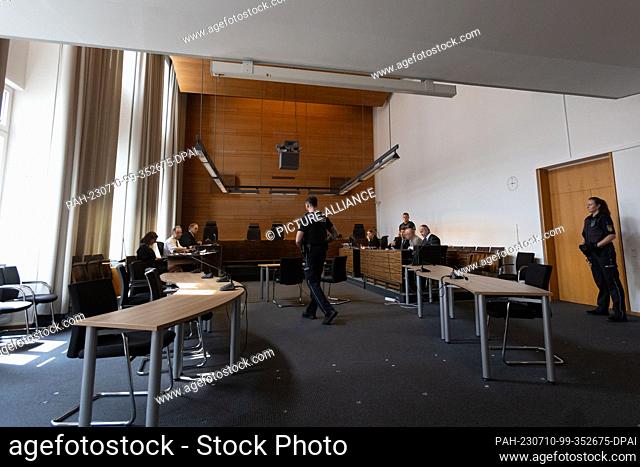 10 July 2023, Baden-Württemberg, Freiburg: A defendant (3rd from right, gray shirt) talks to his defense attorneys. The 63-year-old is accused of attacking his...