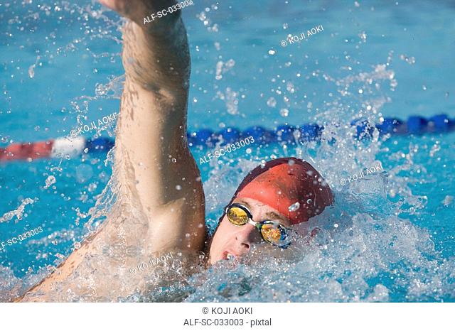 Young swimmer doing front crawl swimming stroke