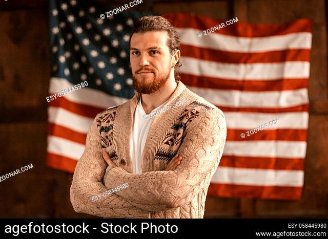 A Young American Businessman Proudly Poses With His Arms Crossed. Attractive Bearded Macho In Casual Feel Confident In American Office