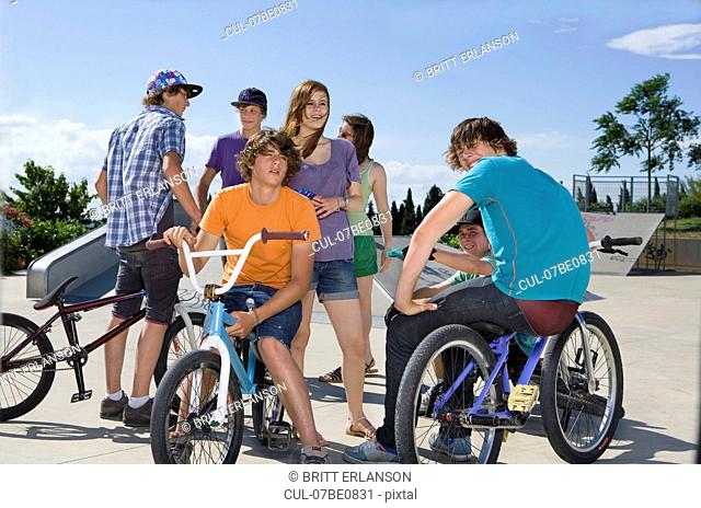Teen group with bikes talking