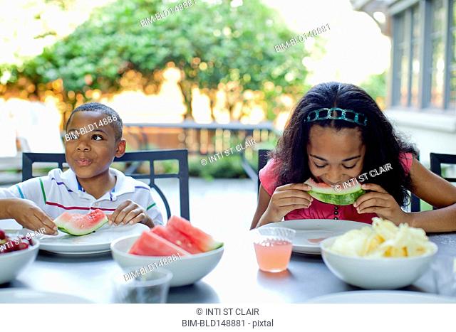African American children eating lunch on patio