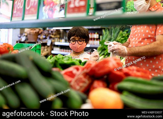 Father and son wearing masks in supermarket