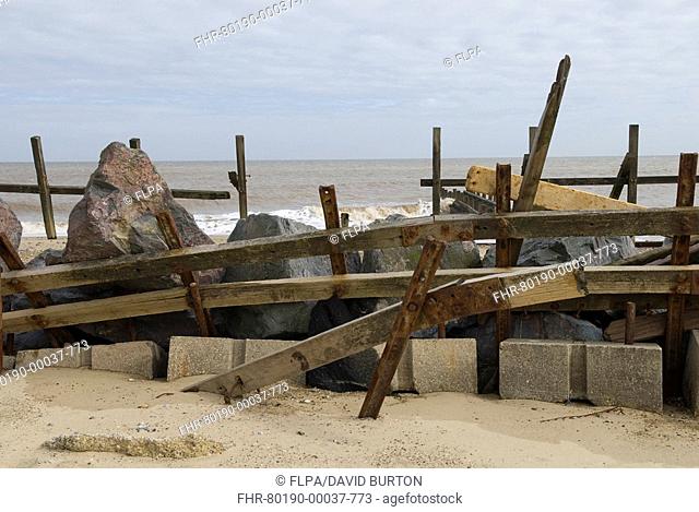 Weathered groynes and rocks, failed sea defences, Happisburgh, North Norfolk, England