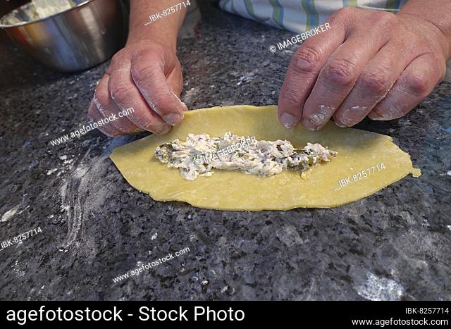Swabian cuisine, preparing hearty doughnuts, Kräpfle with sorrel, filled half moons, filling dough with sorrel cream, hearty, salty shortcrust pastry with yeast