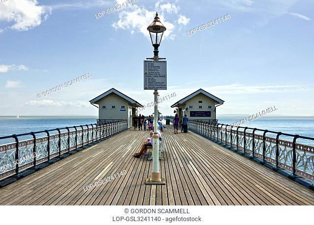 Wales, The Vale of Glamorgan, Penarth. People strolling along Penarth Pier, one of the last remaining Victorian piers in Wales on the north shore of the Severn...