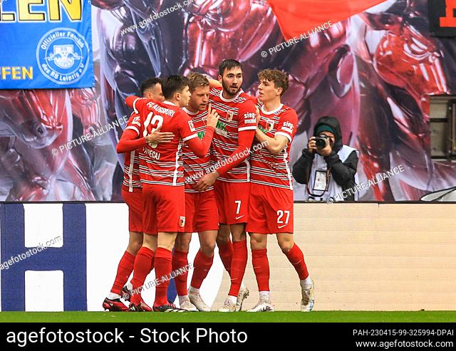 15 April 2023, Saxony, Leipzig: Soccer: Bundesliga, Matchday 28, RB Leipzig - FC Augsburg at Red Bull Arena. Augsburg's players cheer after Arne Maier's 0:1