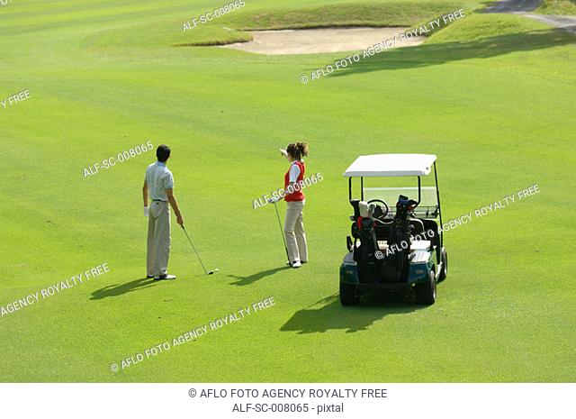 Female golfer pointing out the line to take