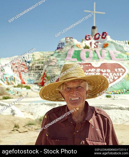 Leonard Knight, creater of Salvation Mountain (background) in the California Desert, north of Calipatria, northeast of Niland near Slab City