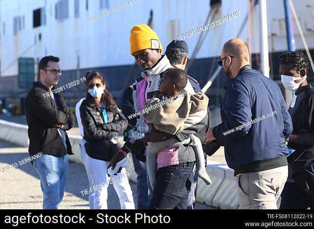 Migrants disembark from the German aid ship Rise Above docked in the port city of Reggio Calabria in southern Italy. The ship landed the 89 people it had...