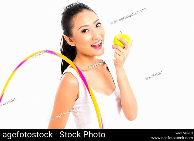 Young Asian woman living healthy and eating fruits