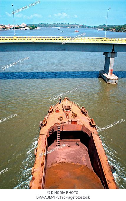 Iron ore transported through shipping on Mandovi river Panji  ; Goa  ;  India NOMR
