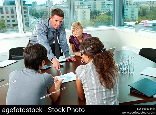 Group of young business people talking on business meeting at office