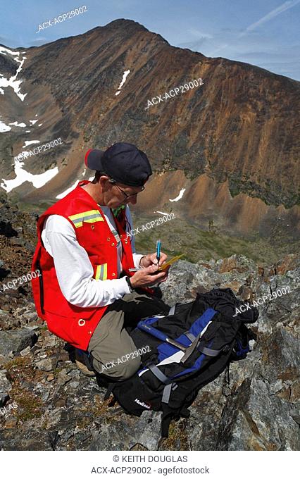 Geologist doing mining exploration fieldwork with GPS, Hudson Bay Mountain, Smithers, British Columbia