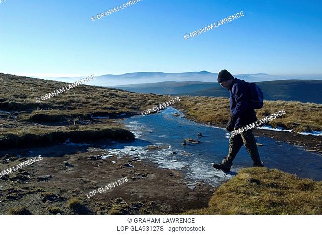 A man walking in the Black Mountains area of the Brecon Beacons National Park