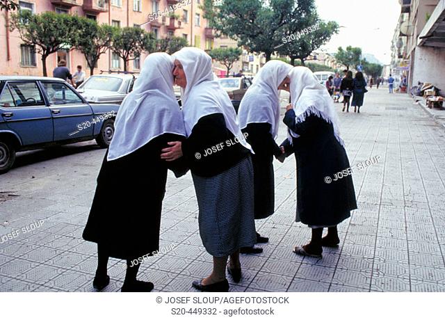 Muslim women: when they meet, they kiss each other on cheeks, according to their custom. Tirana, Albania