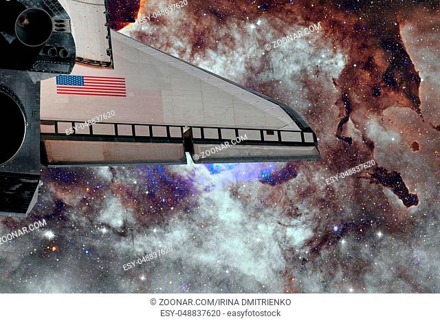 Space Shuttle flight over space nebula. Elements of this image furnished by NASA
