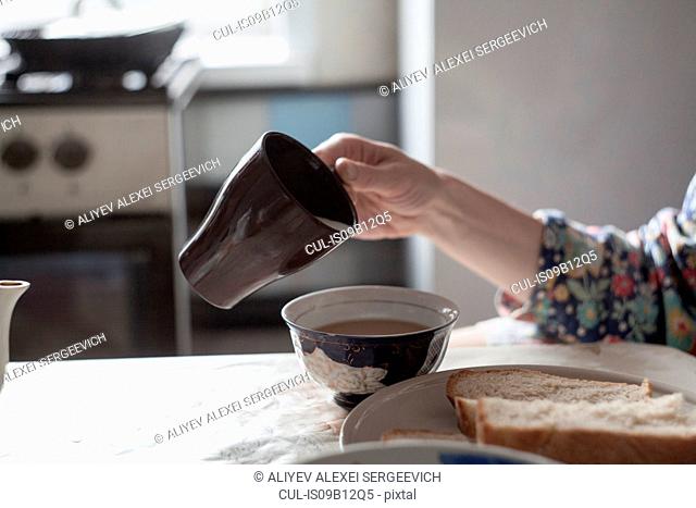 Cropped view of woman making a cup of tea