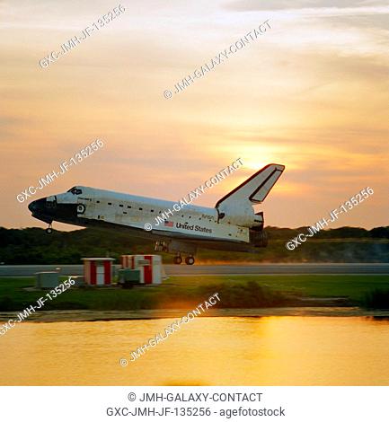 The main landing gear of the space shuttle Discovery touches down on Runway 33 at the Kennedy Space Center to mark the completion of the successful 12-day...