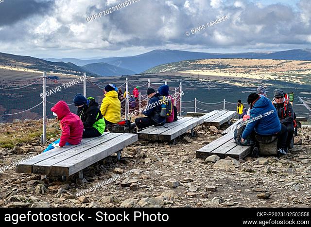 Tourists sit on new benches at the top of Snezka Mountain, Krkonose (Giant Mountains), Czech Republic, October 23, 2023. The benches were created as part of a...