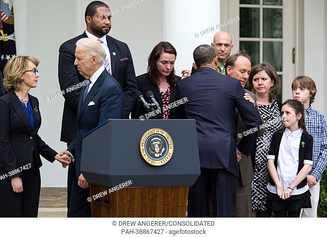 United States President Barack Obama hugs Mark Barden after delivering a statement after gun legislation failed in Congress