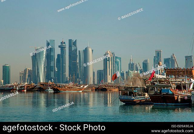 Boats and downtown Doha across water, Doha, Qatar