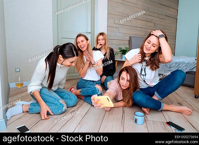 girls on the floor in the apartment have fun