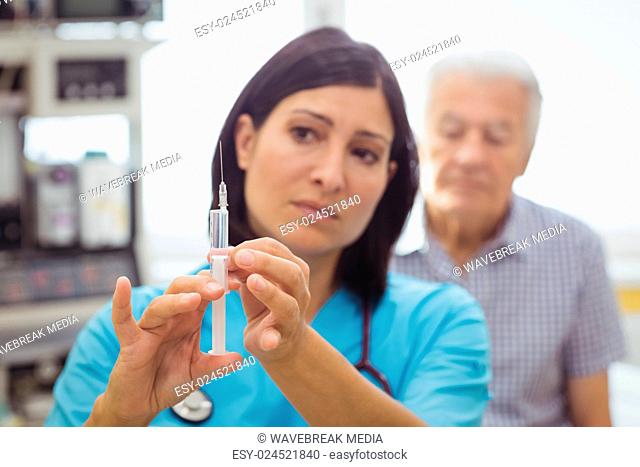 Female doctor holding an injection