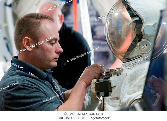 NASA astronaut Michael Fincke, STS-134 mission specialist, participates an EVA simulation session in a space station mock-up in the Space Vehicle Mock-up...