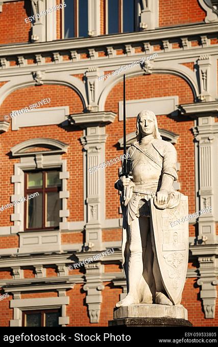 Riga, Latvia. Statue Of Roland At Town Hall Square. House Of Blackheads. Sunny Summer Day With Blue Sky. Famous Landmark. Old Architecture