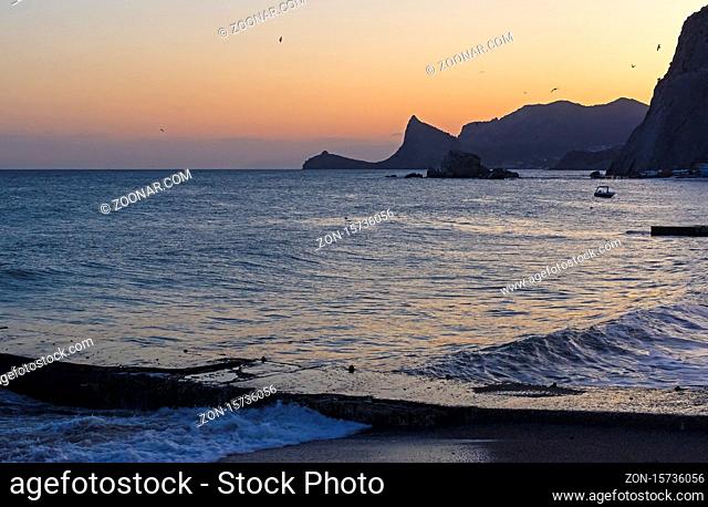 Sunset in the bay of the resort town of Sudak. Crimea