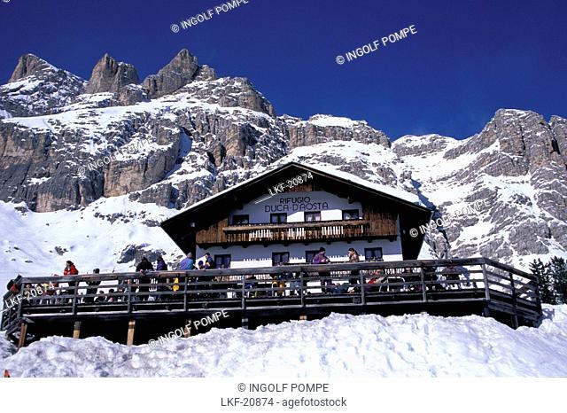 Low angle view of Duca d'Aosta hotel in front of snowy mountains, Tofana, Cortina d'Ampezzo, Dolomites, South Tyrol, Italy, Europe