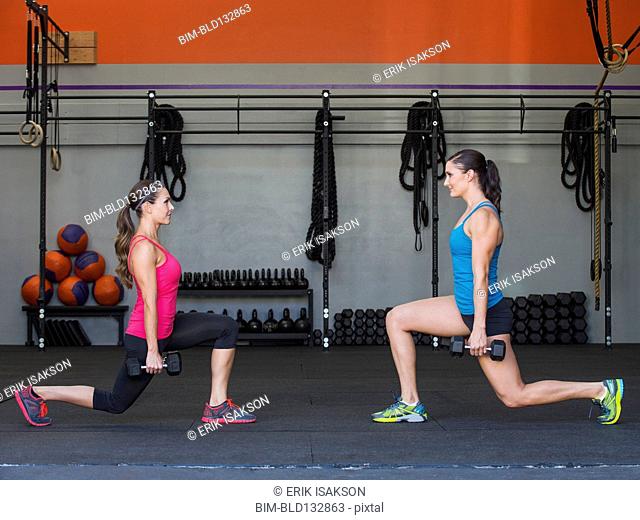 Caucasian women exercising in gym