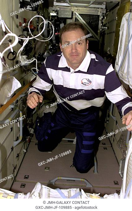 Astronaut James D. Halsell, Jr., mission commander, is pictured inside Zarya or the functional cargo block (FGB) of the International Space Station as the...