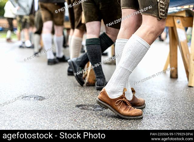01 May 2022, Bavaria, Perchting: Members of the Burschenschaft Perchting stand in their traditional costumes at their maypole at the village square of Perchting