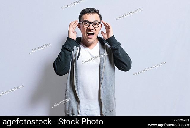 Surprised people opening his mouth, Surprised people with dumbfounded face on isolated background, astonished man holding his head