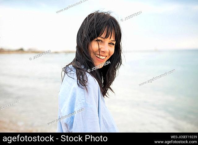 Cheerful woman spending vacations at beach
