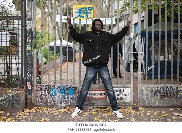 A refugee poses in front of a fence at the Gerhart-Hauptmann-Schule, which is occupied by refugees, in Berlin-Kreuzberg,  Germany, 05 November 2014