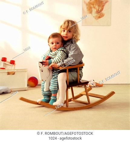 Little Boy and girl on rocking horse