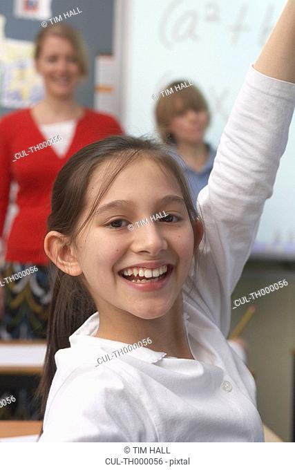 Girl raising her hand in classroom