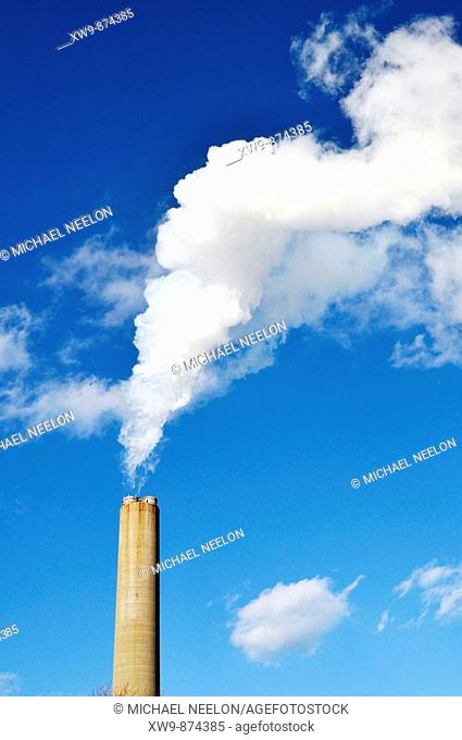 White smoke and smokestack from power plant in United States
