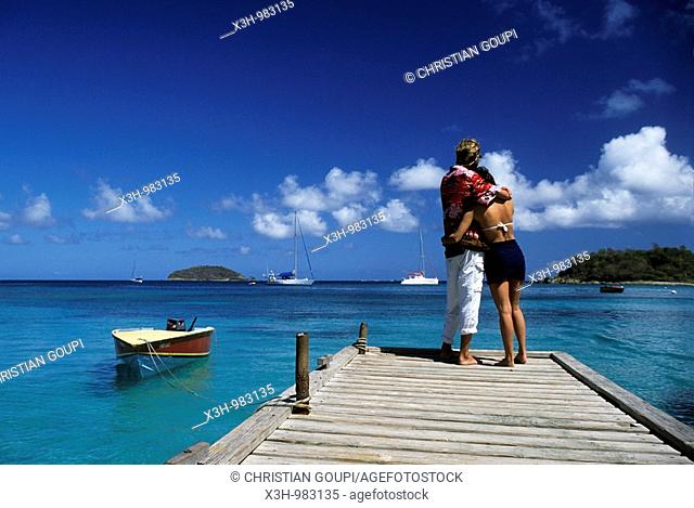 couple on a pontoon in Mayreau, Grenadines islands, Saint Vincent and the Grenadines, Winward Islands, Lesser Antilles, Caribbean Sea
