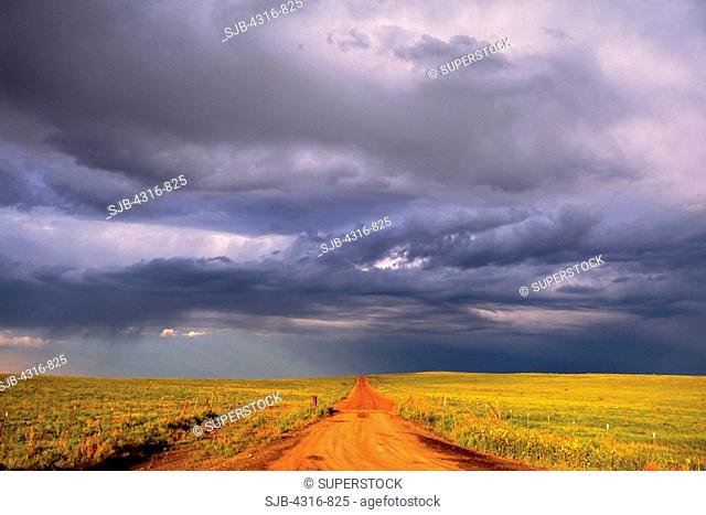 Under the Drama of a Roiling Sky, a Lonely Dirt Road Strikes into the Openness of Colorado's Eastern Plains