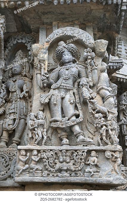 Ornate wall panel reliefs depicting Bhairava, a form of Shiva, Kedareshwara temple, Halebidu, Karnataka, india