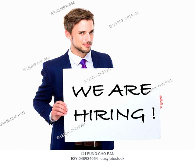 Businessman hold with white board showing phrase of we are hiring